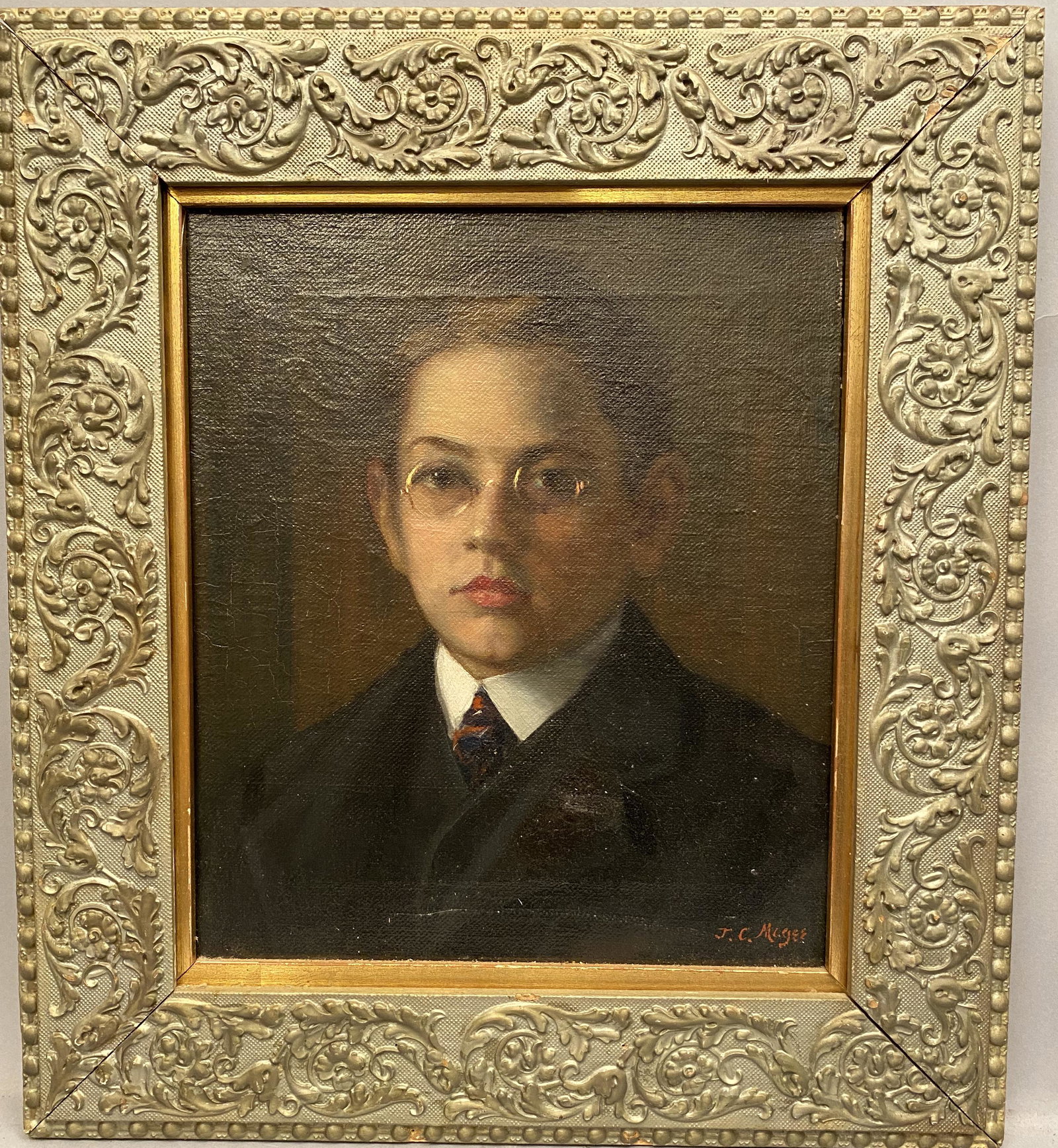 JC Magee Portrait of a Young Man O/C: JC Magee oil on canvas portrait of a young man with glass frame. JC Magee also stamped on the back of stretcher. Sight 13 3/4" x 11 3/4"