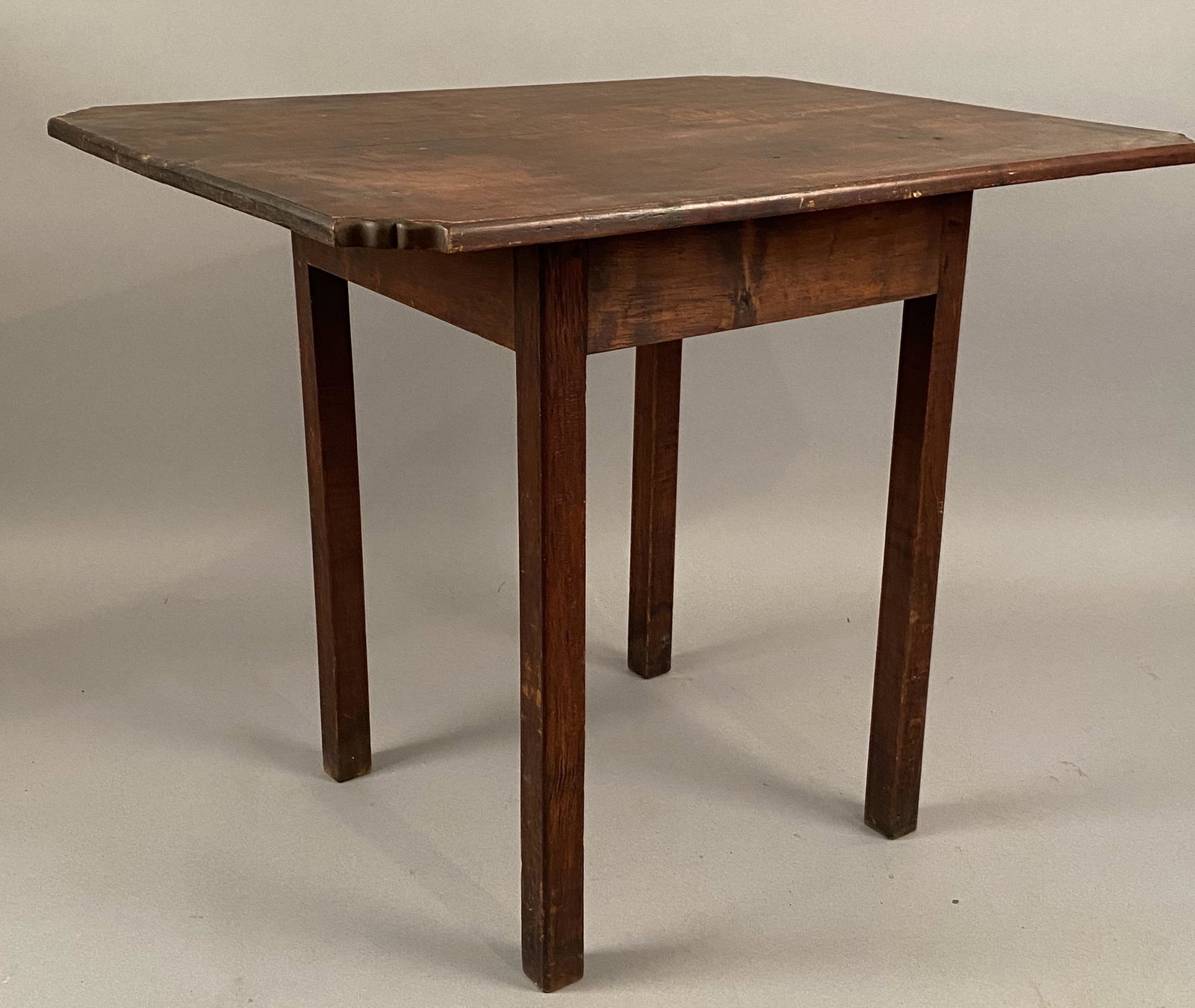 Chippendale Cut Corner Tea Table: Chippendale cut corner table. Touches of tiger figuring can be found throughout the legs and top. Table retains a nice old surface.