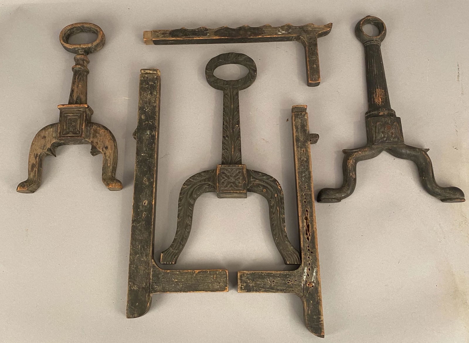 6 Wooden Molds For Casting Andirons or Fire Dogs: Six wooden molds for casting andirons or fire dogs. The molds, carved from wood, include three styles of faces and 3 styles of supports or legs.. Largest item 18 " x 6 "