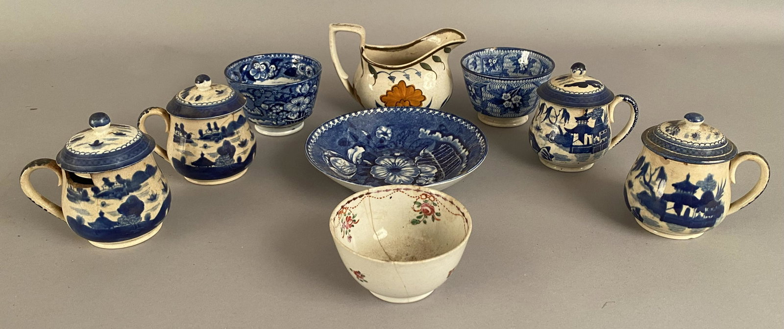 9 Pieces of Early China: 9 pieces of early china. 3 handless cups, 1 plate, 4 covered cups and 1 creamer. Ê7 pieces are blue and white transfer ware. The largest item, the plateÊhas a 6" diameter.