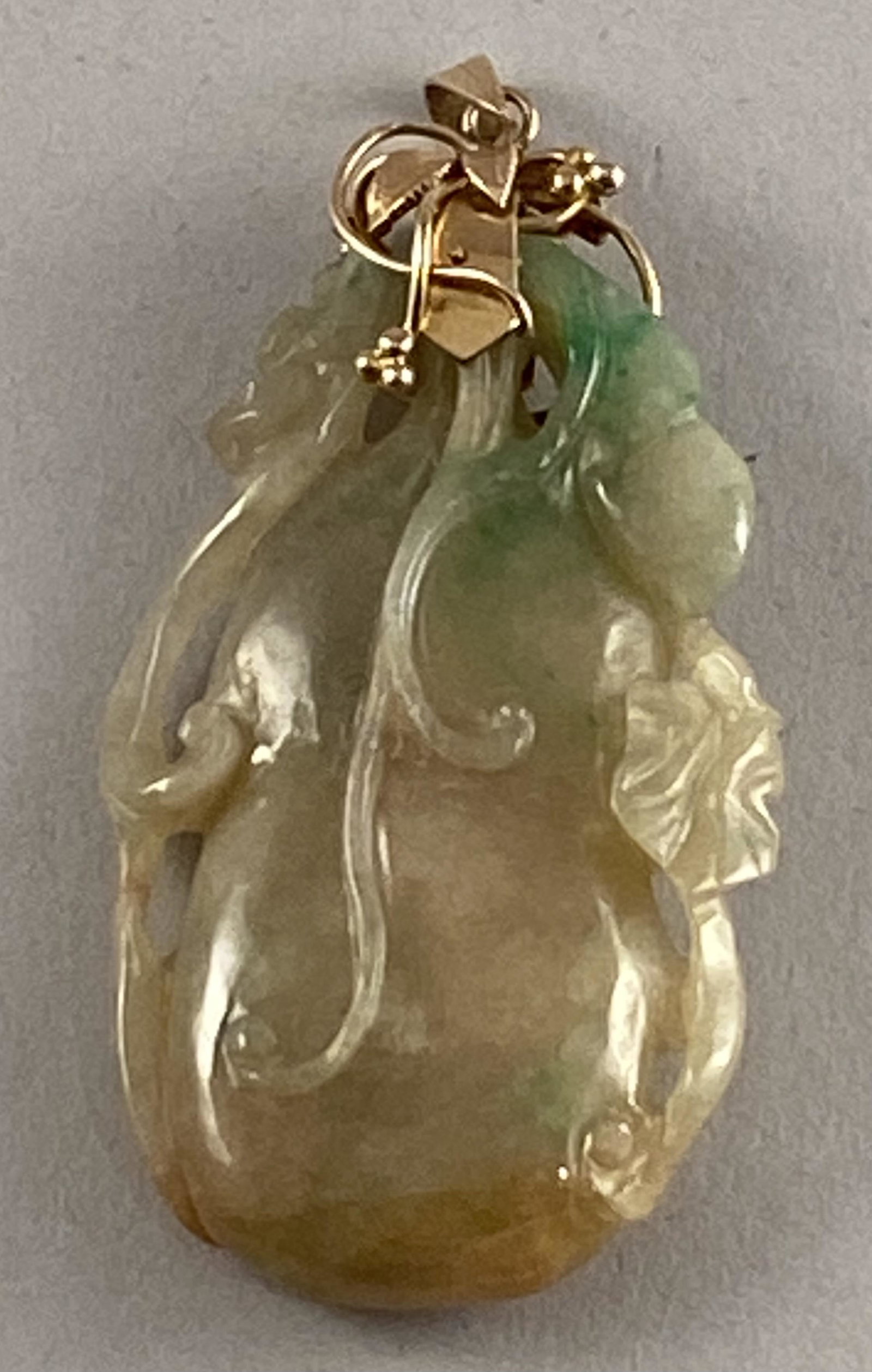 Carved Jade Pendant w/14k Leaf/Berry Finding: Carved jade pendant with 14 karat gold leaf and berry finding. 2 1/2" x 1 1/4"