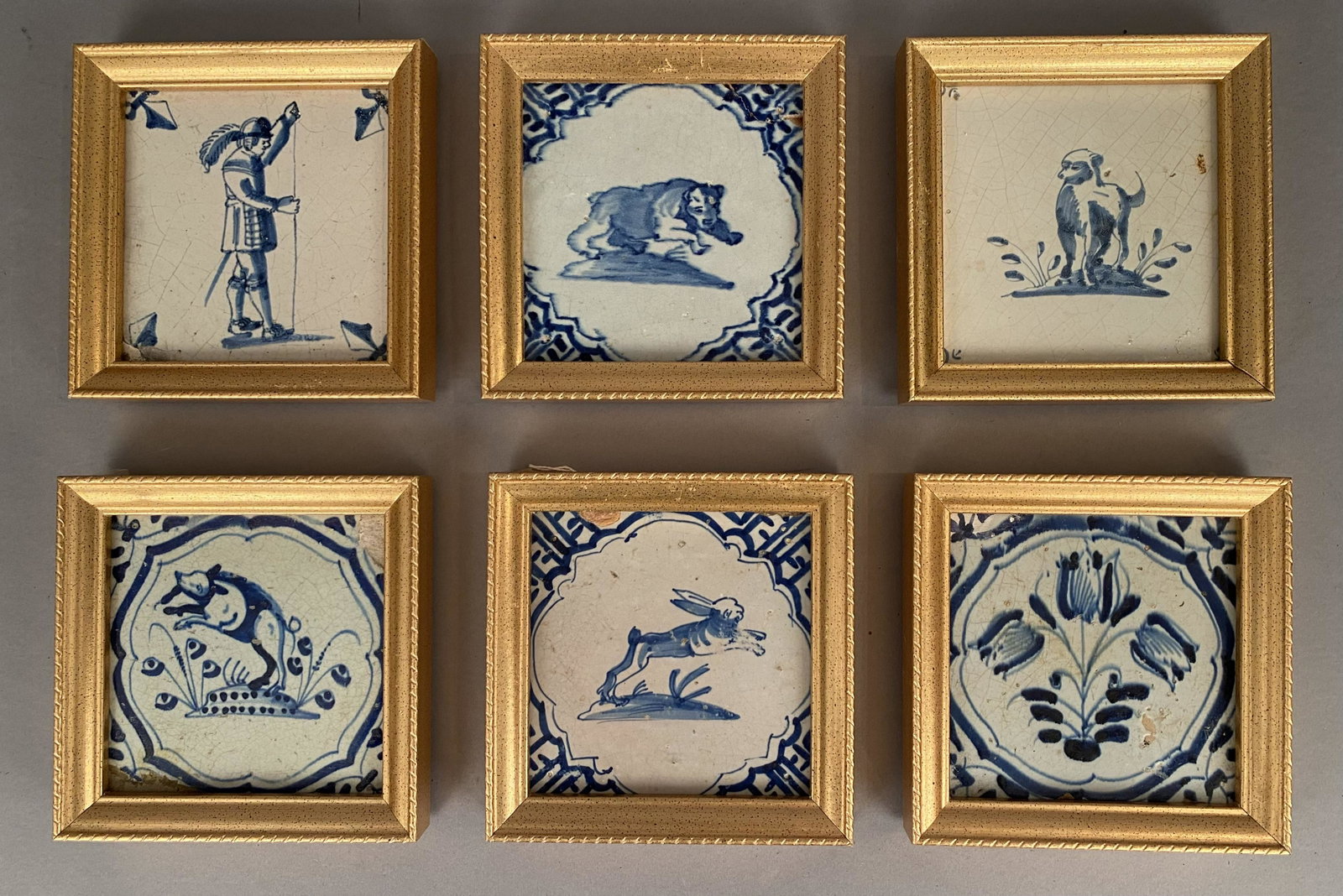 Blue & White Delft Tiles-Soldier, Animals & Tulips: 6 framed Blue and white Delft tiles featuring a soldier, animals and tulips.