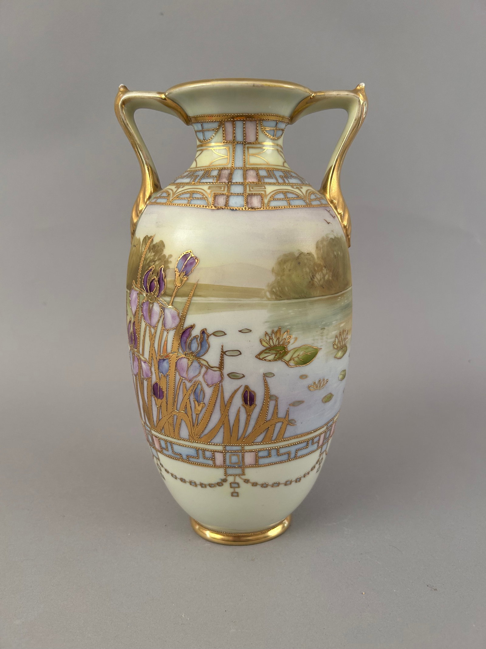 Hand Painted Nippon Two Handled Vase Marsh: Hand painted Nippon two handled vase of a marsh scene with irises and lily pads. Gold details, some raised.