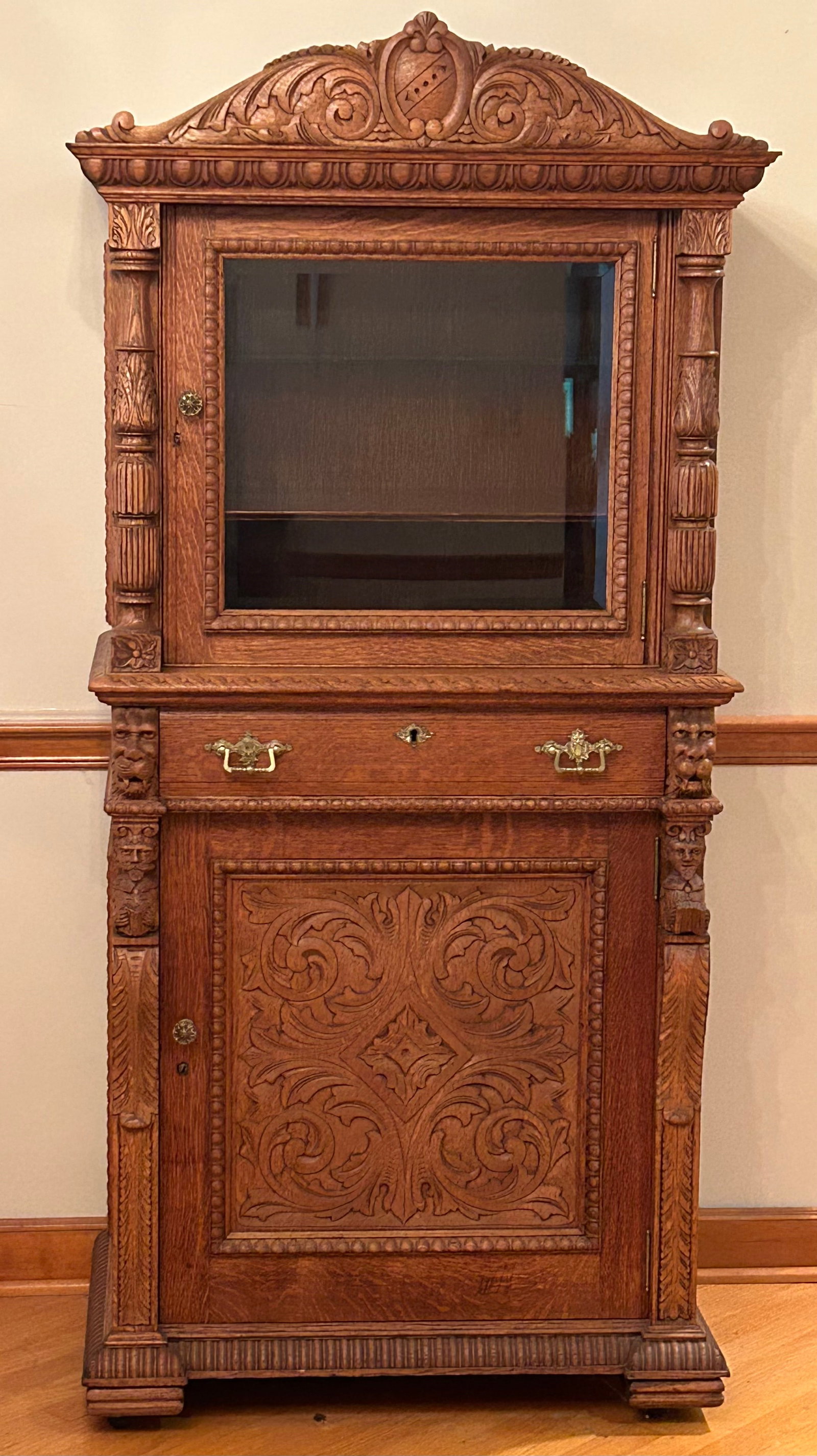 R J Horner Oak Bar Cabinet: R J Horner oak bar cabinet. With carved details, including lion faces, men with goatee, playing accordion, men with mustache reading a book. Carved lower panel, carved base, carved columns, etc. Bevel
