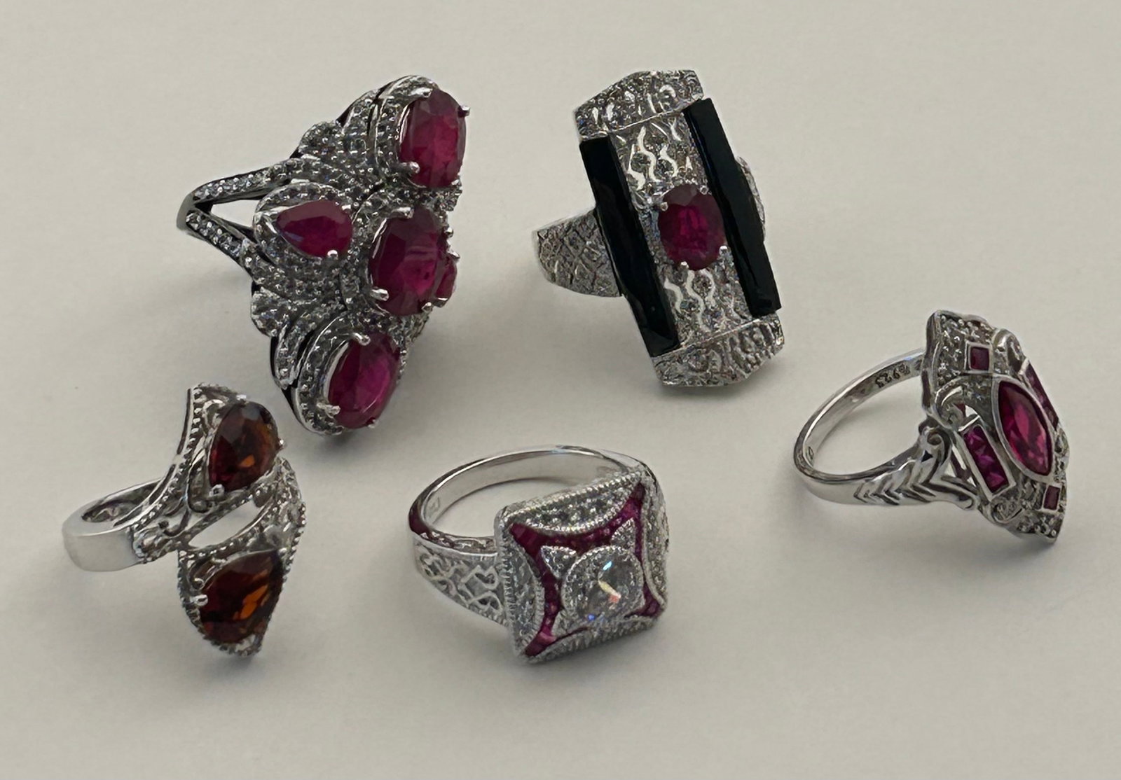 Five Sterling Silver Rings W Red And Pink Stones: Five sterling silver rings with red and pink stones. Possibly pink sapphire, garnet.