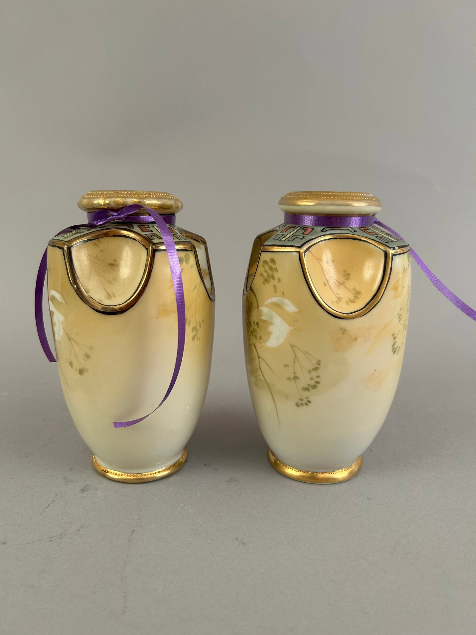 Pair Of Handpainted Nippon Vases: Pair of Handpainted Nippon vases with four indents around the top creating handles. Both marked on the bottom.