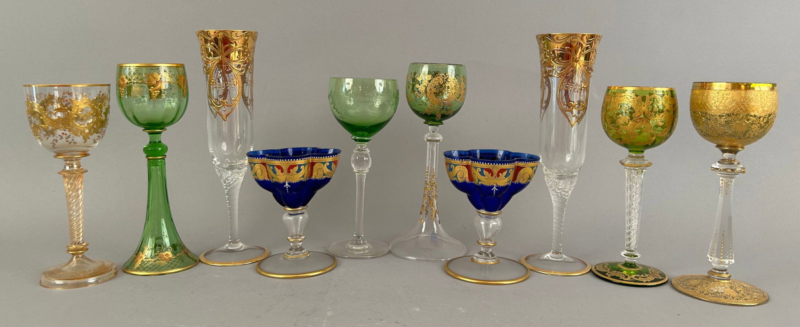 Ten Assorted Pieces Of Stemware: Ten assorted pieces of stemware with varying colors, sizes and patterns. Most with beautiful gold detailing.