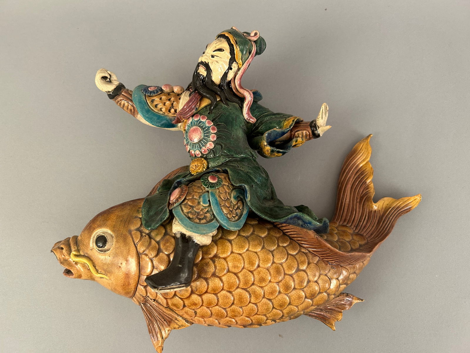 Chinese Roof Tile Of A Man Riding A Carp: Chinese roof tile of a man riding a carp.
