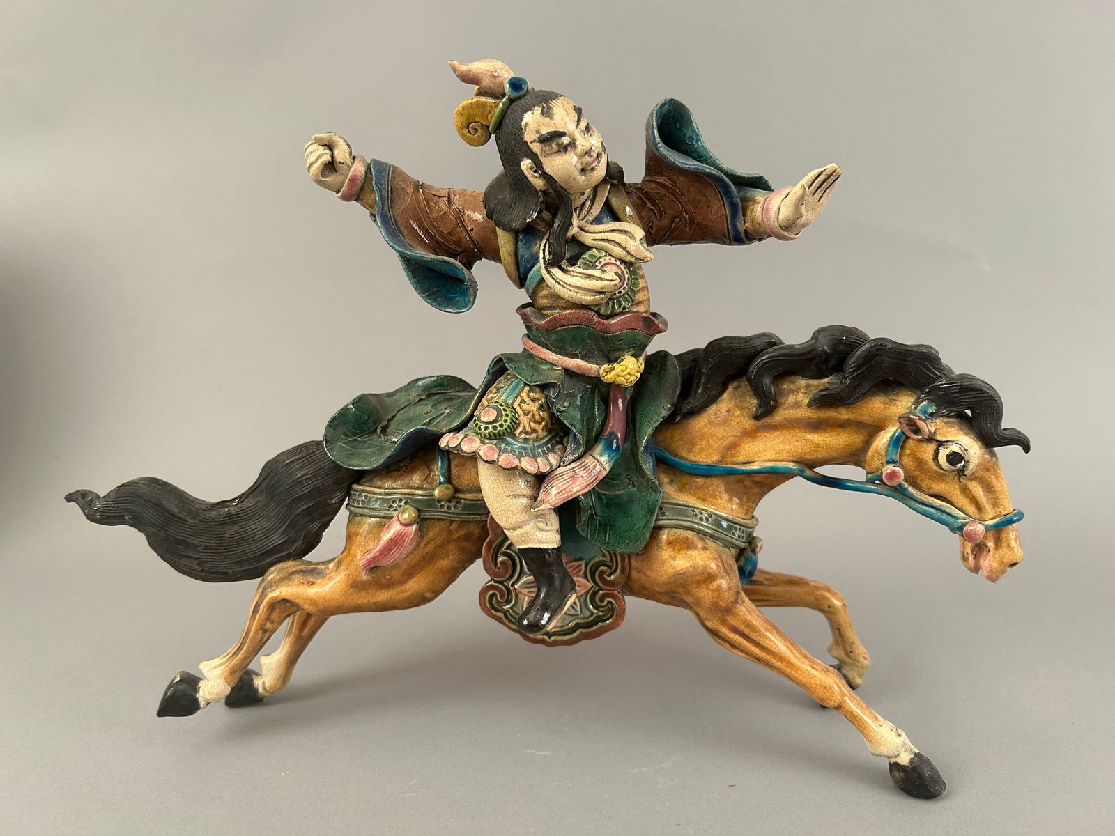 Chinese Roof Tile Of A Man Riding A Horse: Chinese roof tile of a man riding a horse.