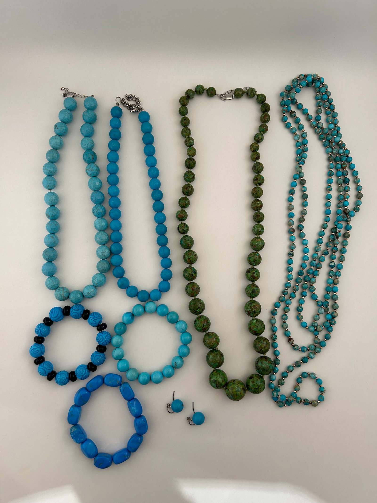 Eight Pieces Blue And Green Bead Jewelry W Turquoise: Eight pieces blue and green bead jewelry including four necklaces, three bracelets and pair earrings. Necklaces marked with Sterling clasps. Lots of Turquoise.