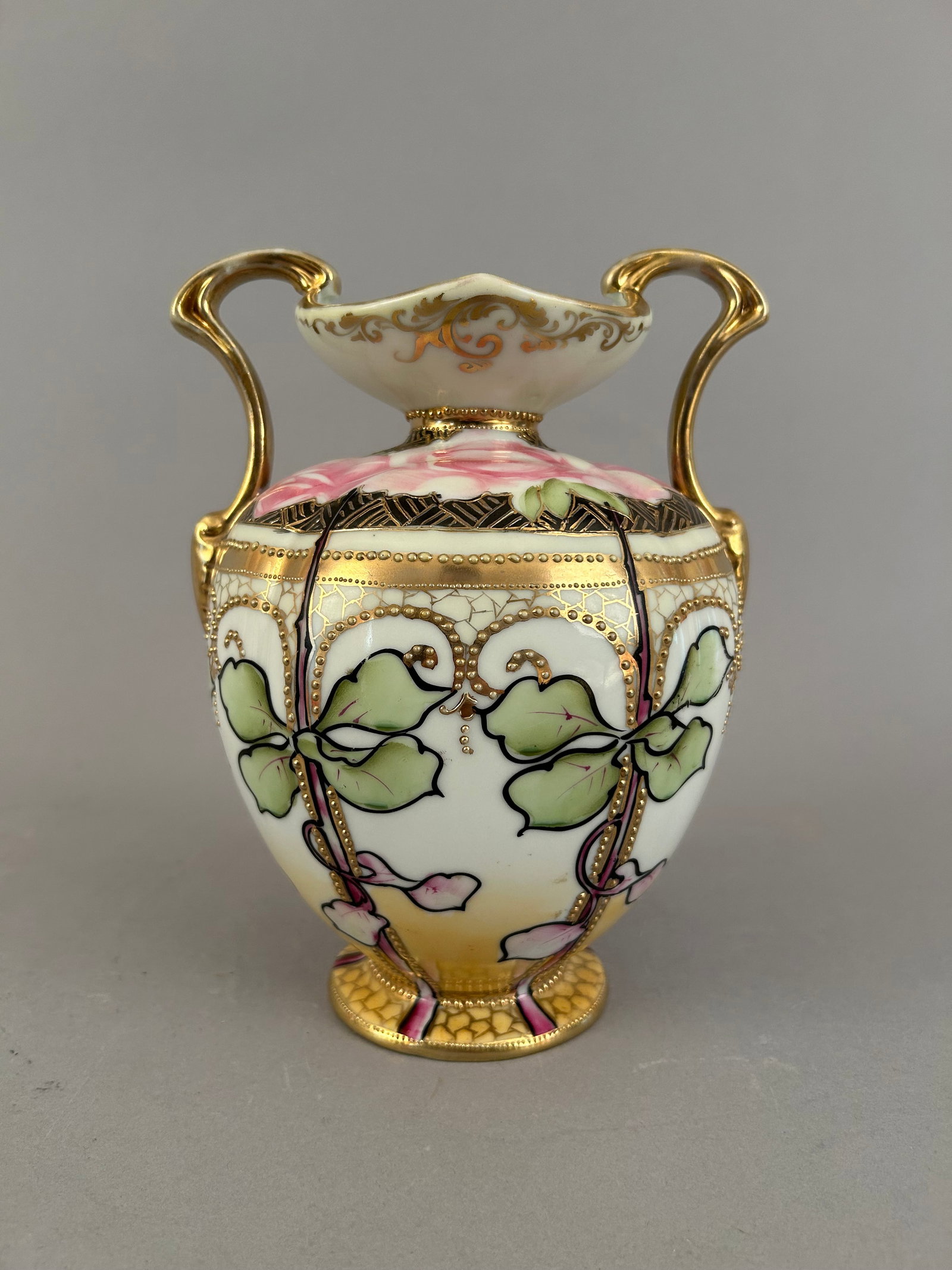 Hand Painted Nippon Two Handled Vase With Roses: Hand painted Nippon two handles vase with roses and some heavy black outlines. Gold raised detailing. Marked on the bottom.