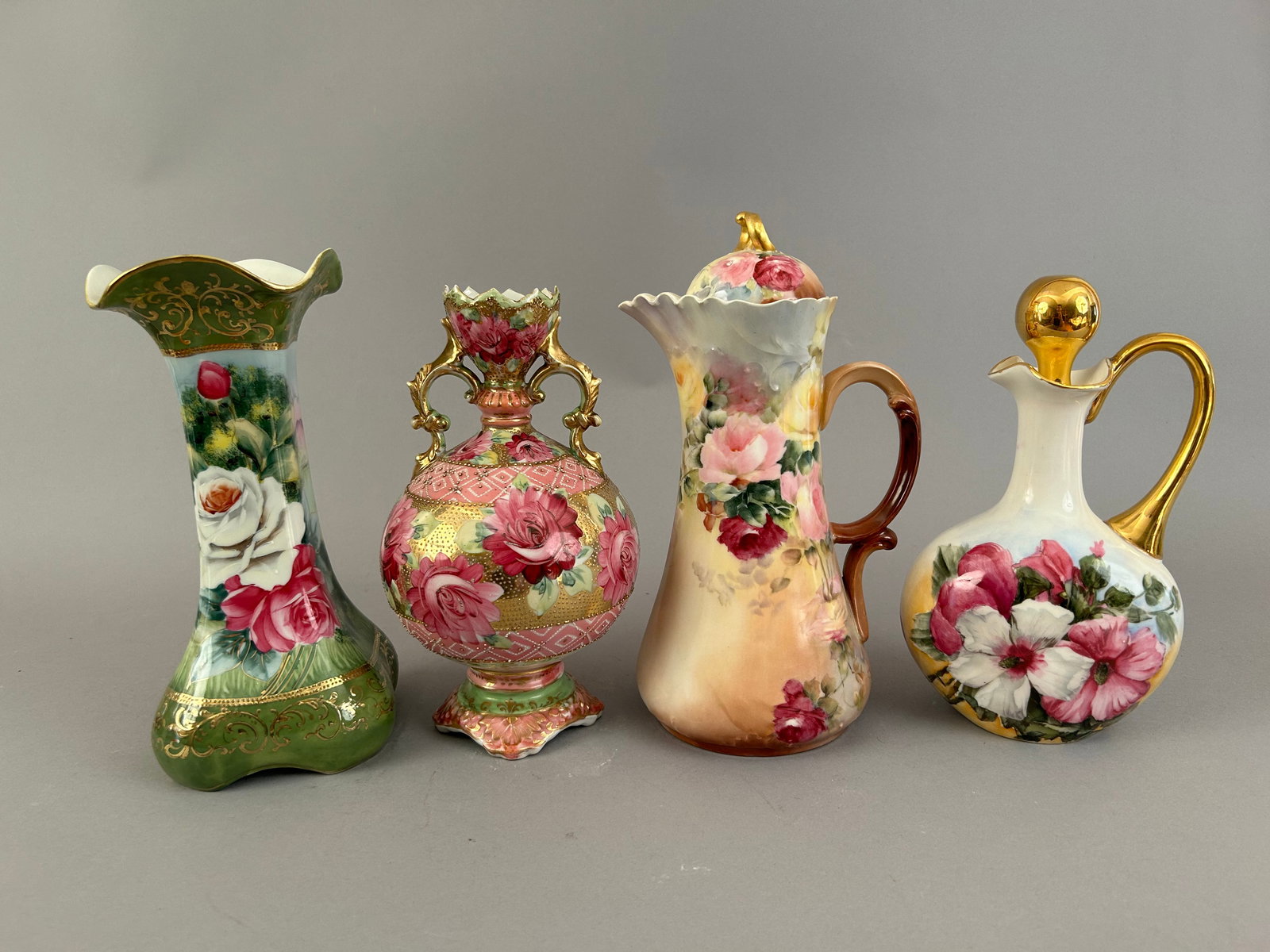 Four Hand Painted Porcelain Pitchers And Vases: Four hand painted porcelain pitchers and vases. Two pitchers are Limoges, one vase Nippon and the other unmarked.Ê