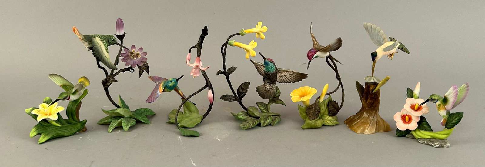 Seven Humming Bird Figurines In Assorted Poses: Seven humming bird figurines in assorted poses.Ê Six are bisque porcelain from Franklin Mint designed by Cecile Bruner. Some have original stickers on bottom.