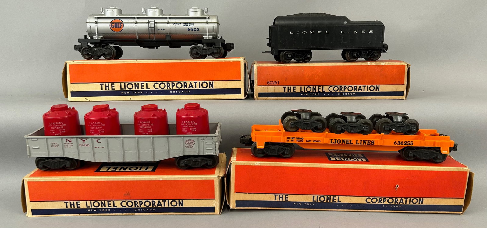 Four Lionel Train Cars with Boxes O Gauge: Four Lionel Train Cars with Boxes, 6362 Truck Car, 6562-1 NYC Gondola Car, 6425 Gulf Tank Car and 6026T Tender. O Gauge