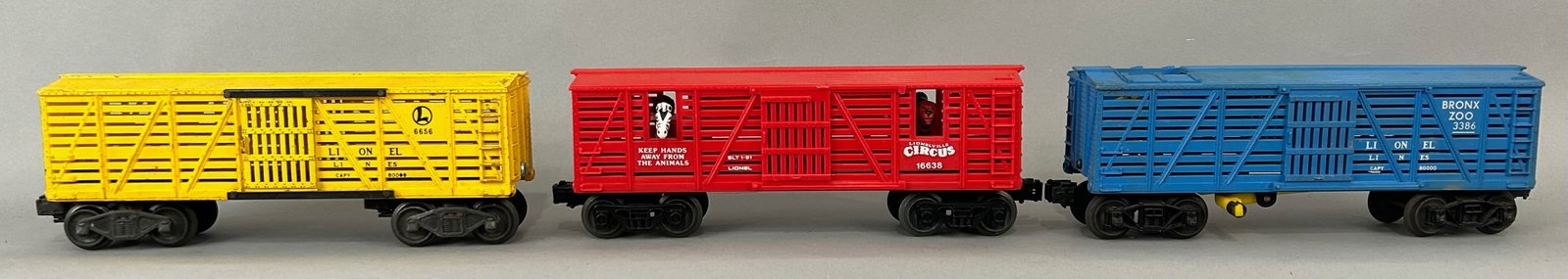 Three Lionel Stock Cars, 2 w Animals O Gauge: Three Lionel Stock Cars, 6656, 16638 Bobbing Lionelville Circus Animal Transport Stock Car, and 3386 Bronx Zoo Giraffe Car. O Gauge