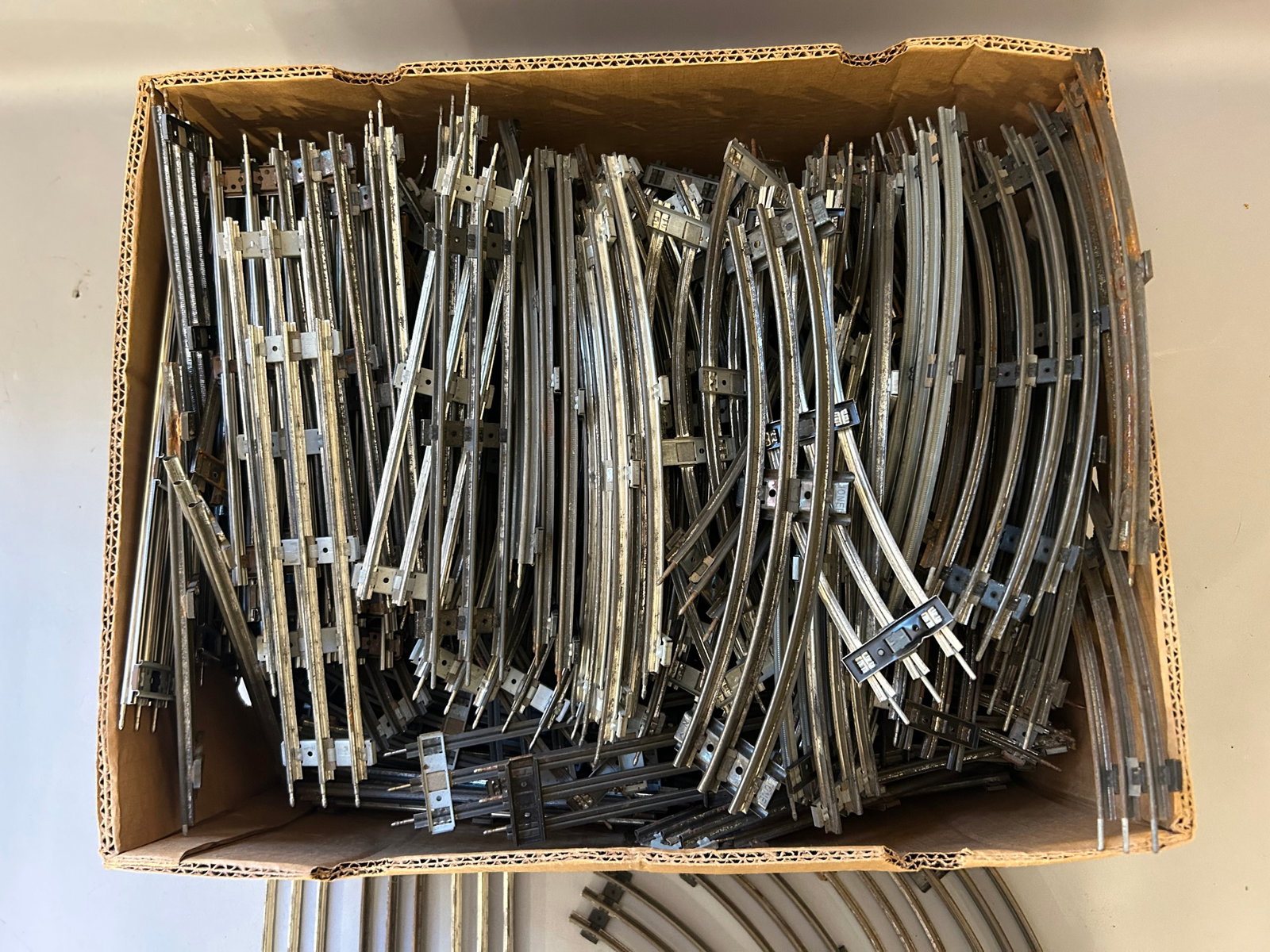Box of track O Gauge: Box of track. Two rail. Mostly Lionel, 40+ pieces, streets, and corners.