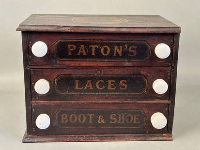 19th c Three Drawer Spool Cabinet Paton's Boot & Shoe Laces: 19th century three drawer spool cabinet Paton,s Boot & Shoe Laces?. Scotland original advertising emblem on top. Original painted panels, porcelain knobs 14” x 9” x 11”Provenance: