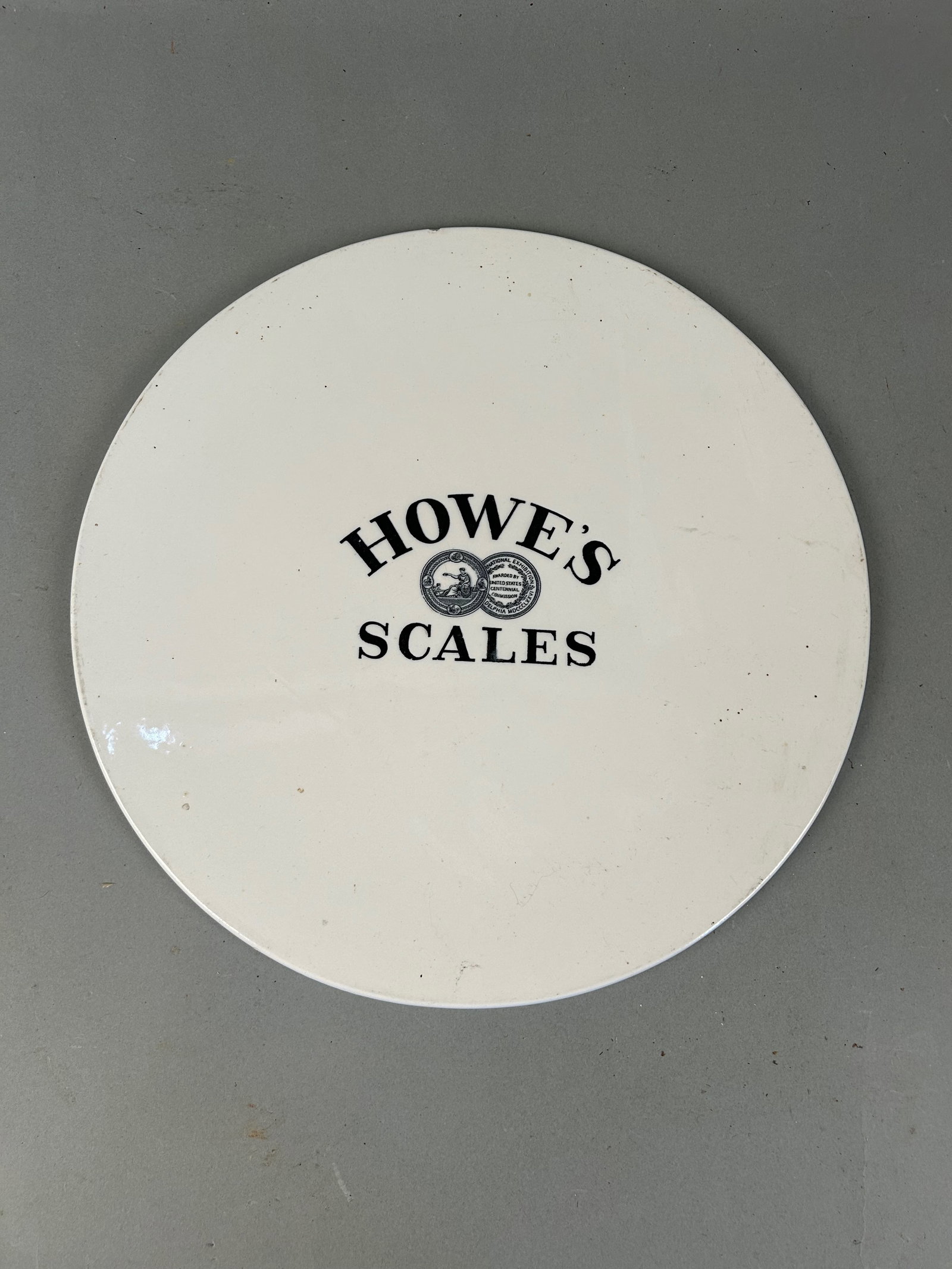 Howe's Scales White Porcelain Tray: Howe's Scales white porcelain tray. 13.5" diameter x 7/16" thickProvenance: Robert and Jane Cottingham Collection Newtown, CT
