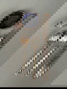 4 Pieces Georg Jensen Sterling Acorn Pattern: Four pieces of Georg Jensen Sterling. Two matching demitasse spoons in acorn pattern. Butter knife and open salt. Enamel damaged, sterling as is on open salt only. Two felt holders. Knife 6 inches. To