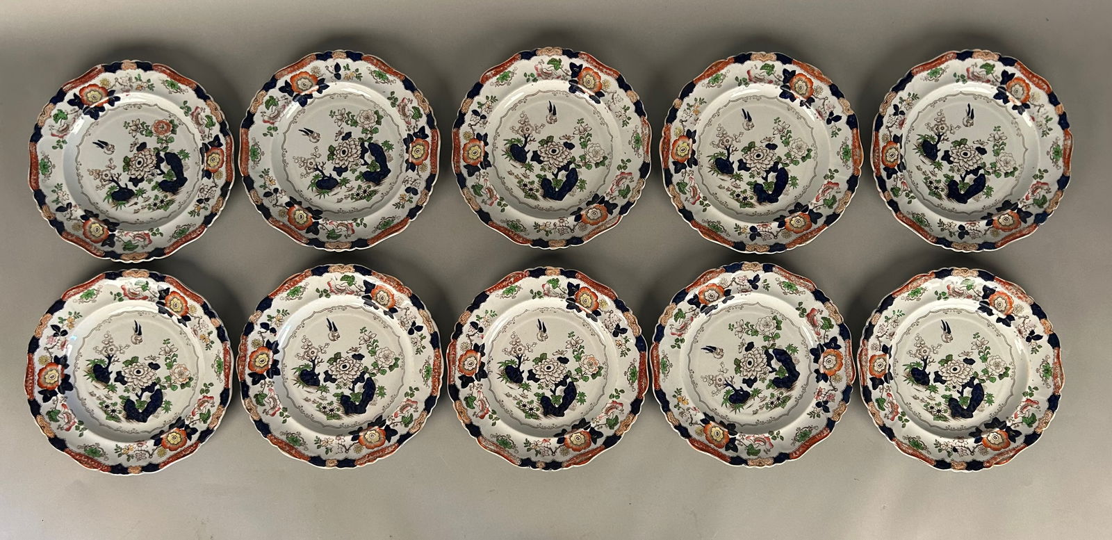 Set a 10 in Imari ironstone China plates: Set a 10 in Imari ironstone China plates. Marked with crown ?real stone China? on the universe. Floral pattern with bird and butterfly.