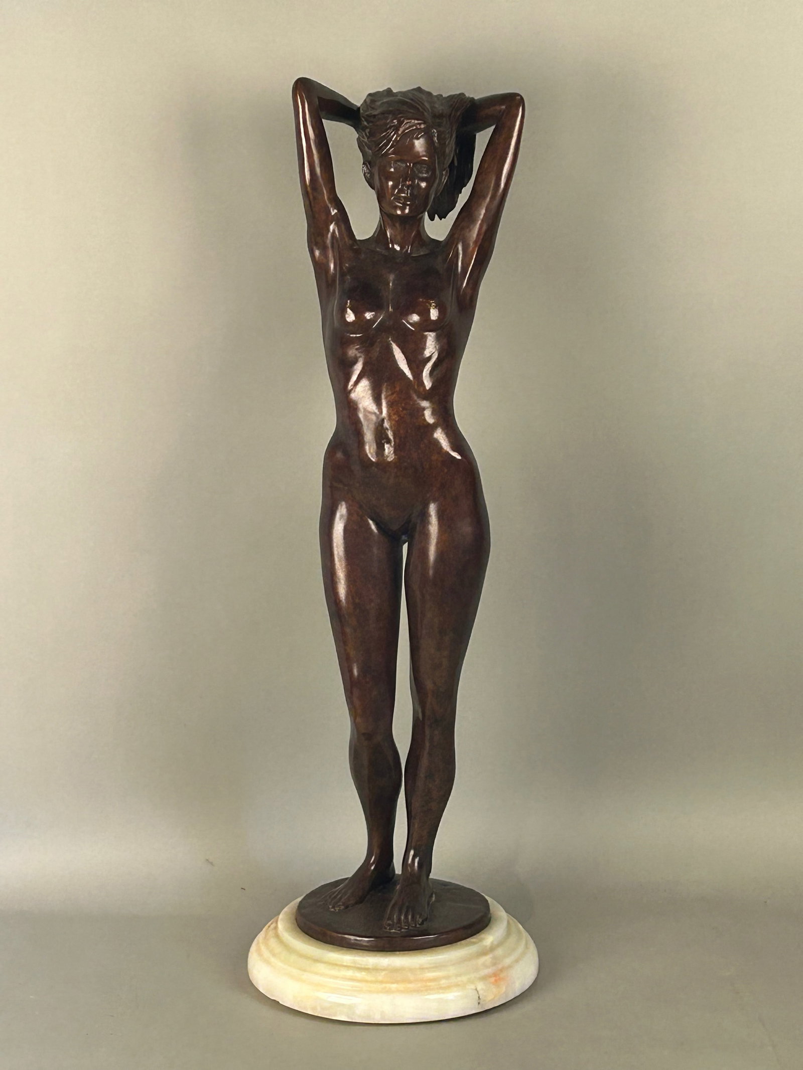 Cast Bronze Statue of Nude Woman on Revolving Marble Base: Cast bronze statue of nude woman, on revolving marble base. Signed R. L.? 4/25. Dated 1990. 33 1/2 inch tall 11 inch diameter.