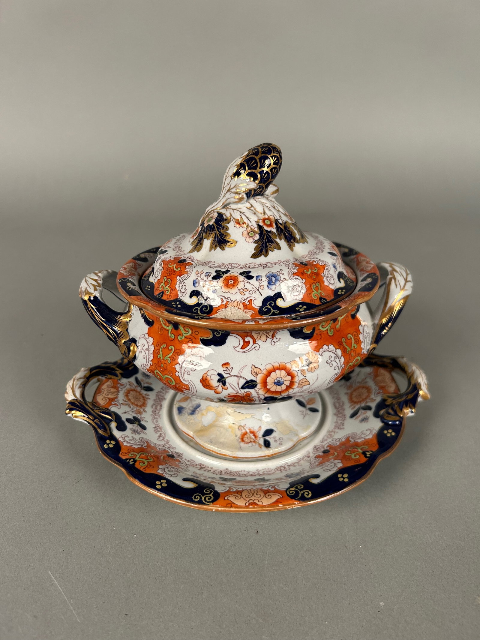 Small Imari ironstone soup tureen w liner: Small Imari ironstone soup tureen with liner. English lion and unicorn and crown mark on underside. Eight and three-quarter inches by 7 1/2” x 7” tall to lid, repair to footed base.