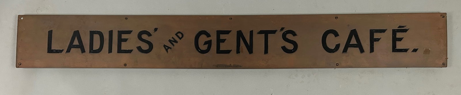 Vintage Brass Ladies & Gents Cafe Sign: Vintage Cafe sign, Boston. Ladies and Gent's Cafe brass sign mounted on wood. Made by T F McGann, Boston. 7" x 55 1/4" very good condition, nice patina.Provenance: Robert and Jane Cottingham Collectio