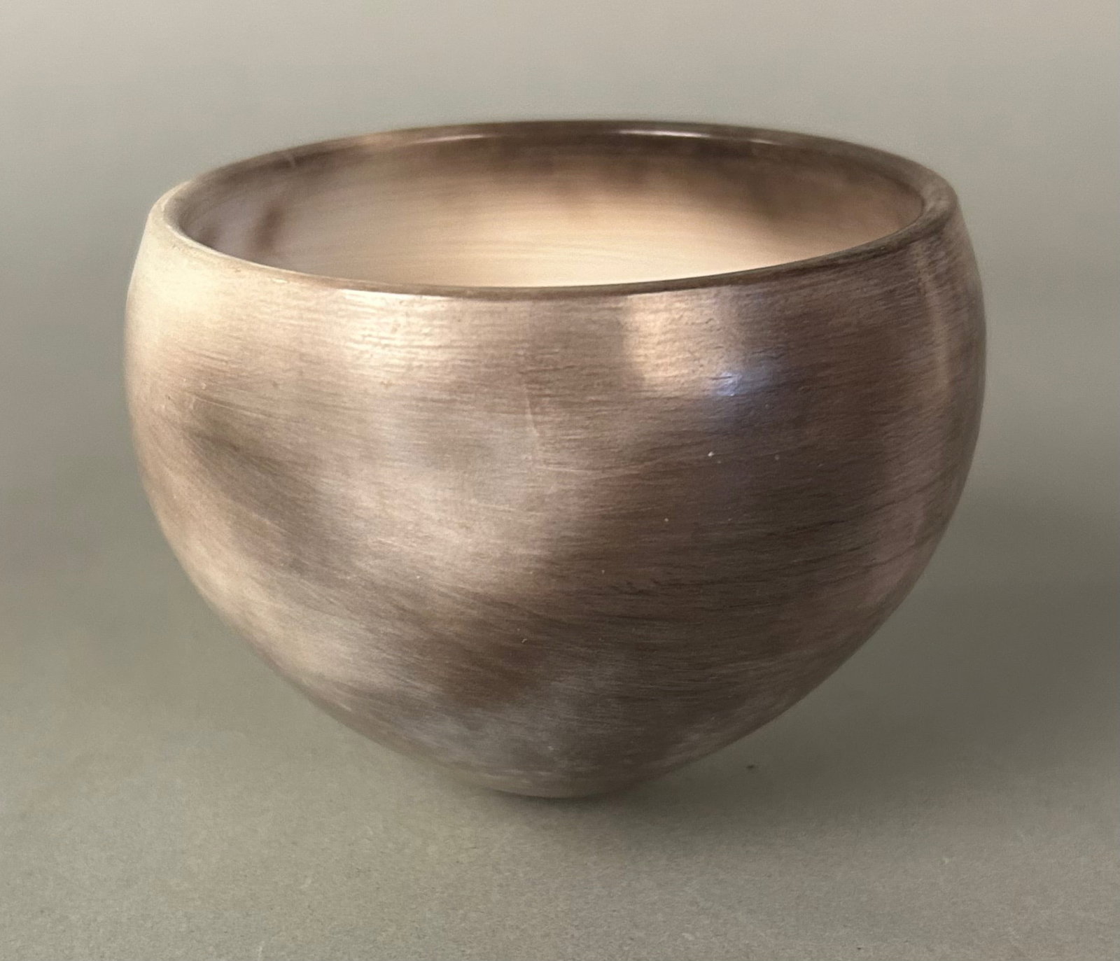 Studio Art Pottery Bowl, Signed Muller? 20th century: Studio Art Pottery Bowl, Signed Muller? 20th century.Hand-thrown stoneware bowl with softly rounded form and subtly mottled, metallic-toned glaze; underside incised with a cursive signature incorporat