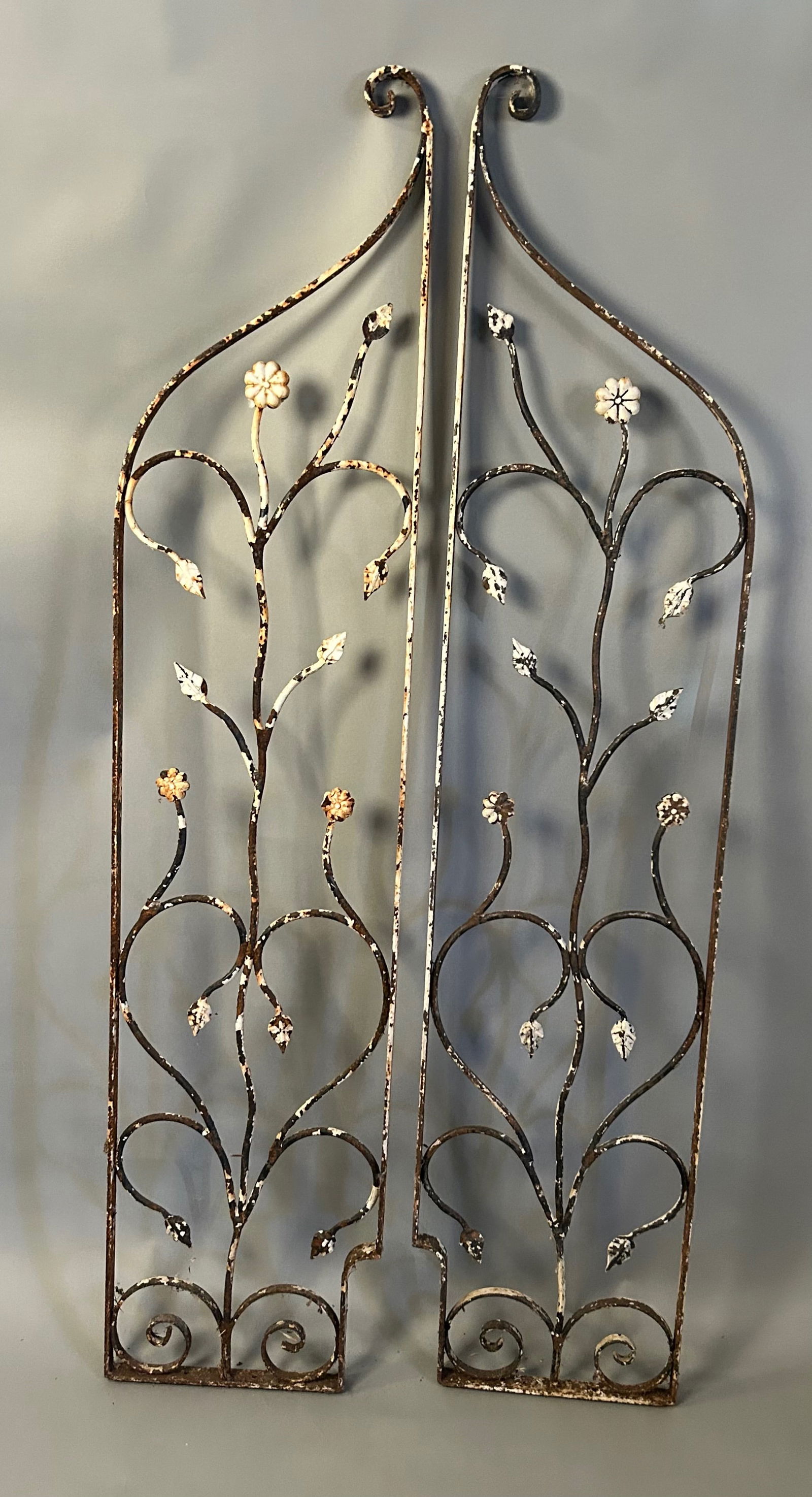 Pair of Decorative Wrought Iron Panels: Pair of Decorative Wrought Iron Panelslate 19th–early 20th century2 Hand-forged iron panels, each with scrolling foliate vines and stylized floral elements, surmounted by arched crests with curled t