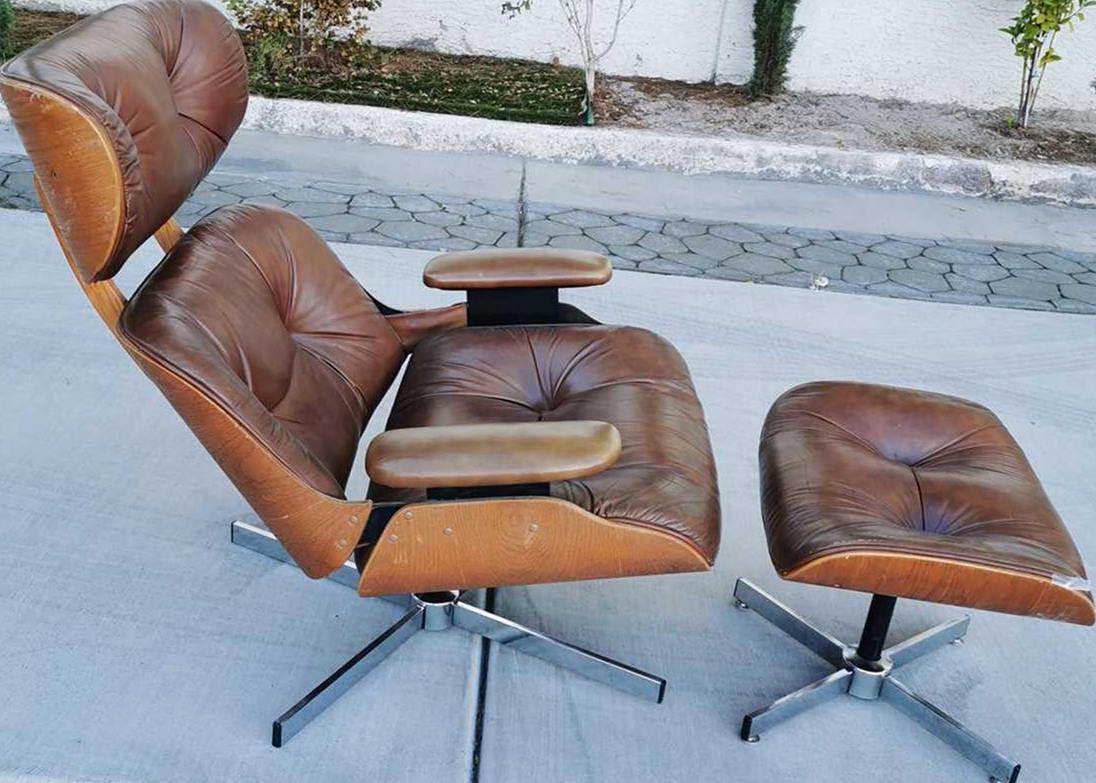 810-"HERMAN MILLER" OAK CHAIR & OTTOMAN: 810 - "Herman Miller" oak chair and ottoman, with a Charlton red logo on the bottom of the seat cushion, a line of white paint on the back of the back, no damage or stains, natural aging due to age is