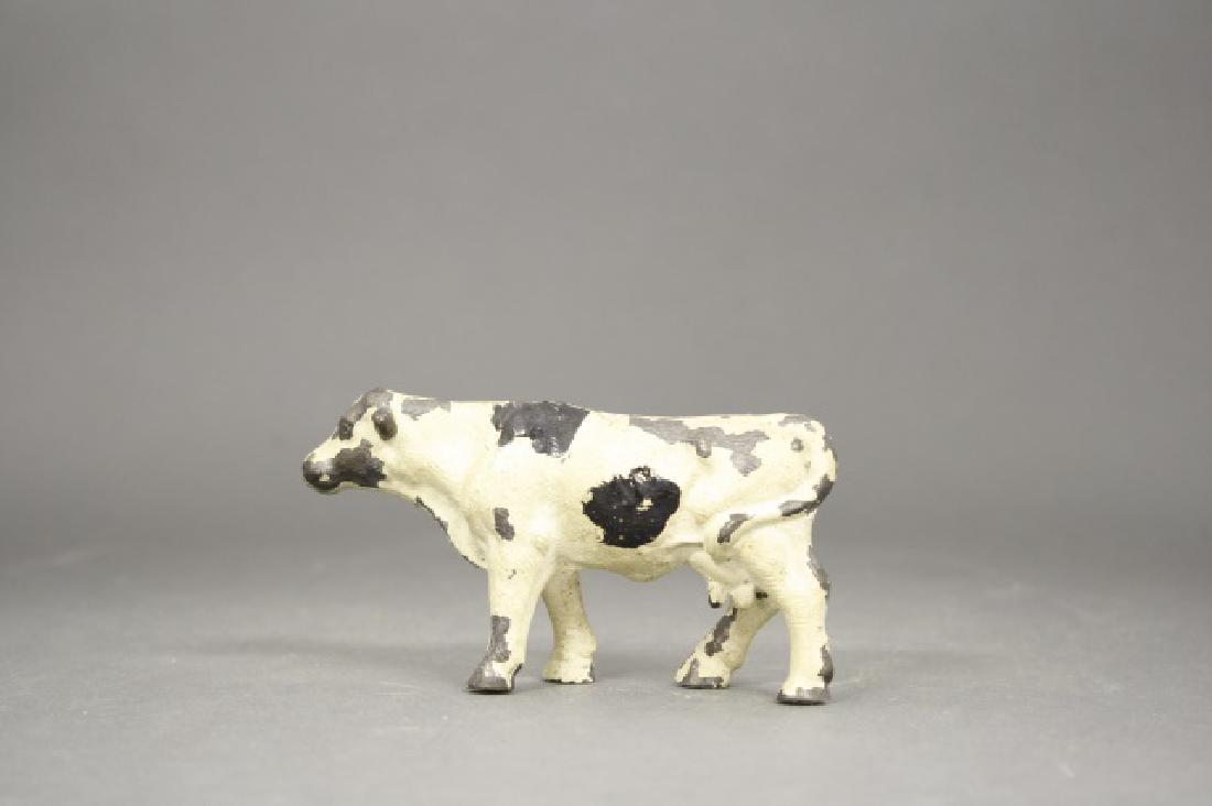 Holstein Cow: Made by Arcade. Cast Iron. 2 1/2" H. Fine Condition.