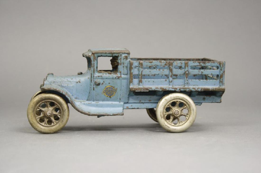 Stake Truck: Made by Arcade circa 1920's. Cast Iron. 7 1/2" Long. Fine Condition.