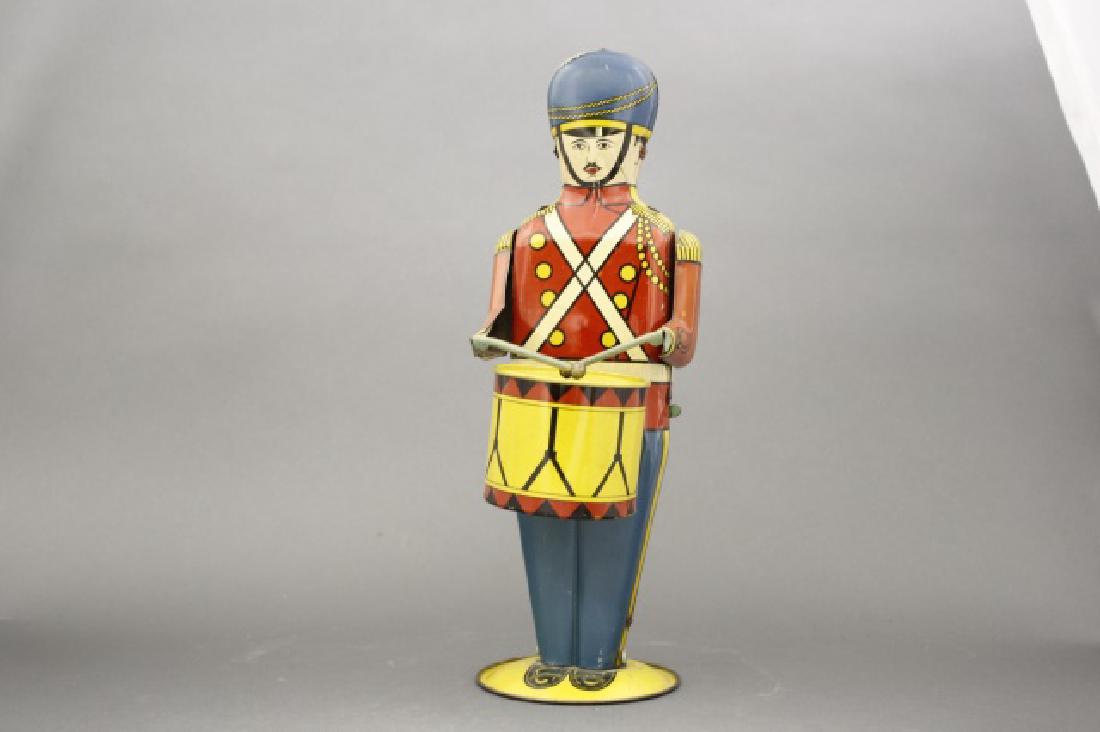 Drummer: Made by Wolverine Supply & Mfg. Co. of Pittsburg circa 1935. 13" Tall. Tin. Excellent Condition. He is in working condition.