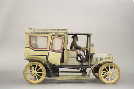 Carette Sedan with Chauffeur: Made by Georges Carette of Germany circa 1912. Tin and Glass. 12" Long. This is the deluxe version with two rear passengers. One door missing its handle. Fine Condition. The toy is in working conditio