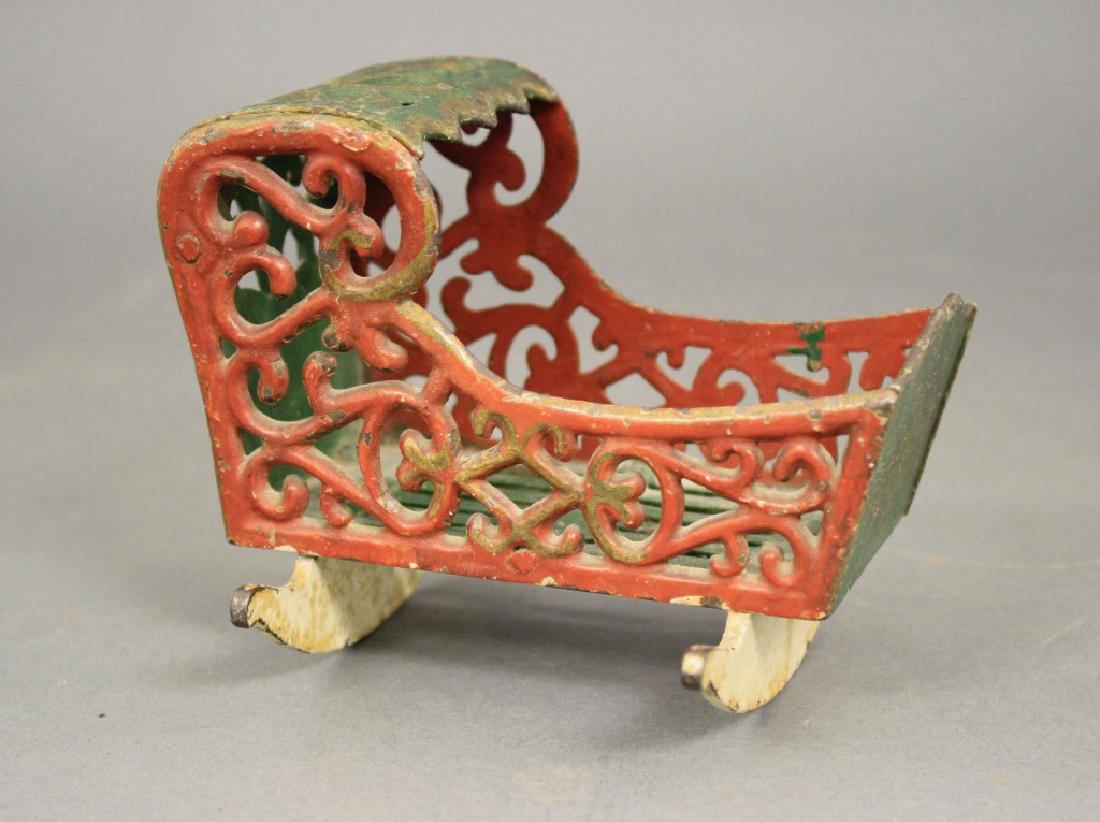 Cradle: Made by Stevens & Brown circa 1875. Cast Iron. 5" L. Very Fine Paint (One Runner Broken).