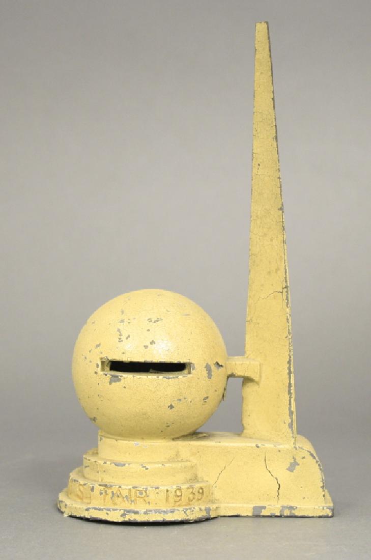 New York World's Fair 1939 Bank: Made of White Metal. 7 3/4" H. Good Paint Condition (Cracks to base, tip of spire broken off and missing, no trap).