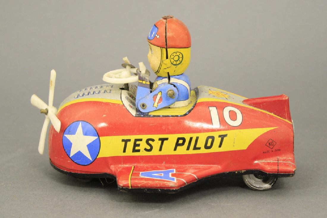 Test Pilot Tin Windup Toy: Made of Tin and Plastic. 6" L. Marked "Made in Japan". In Very Fine Condition.