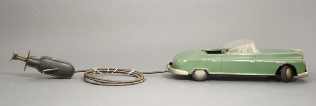 Convertible: Made by Arnold, Western Germany circa 1955. Made of Tin. 9.75" Long. Fine Condition.