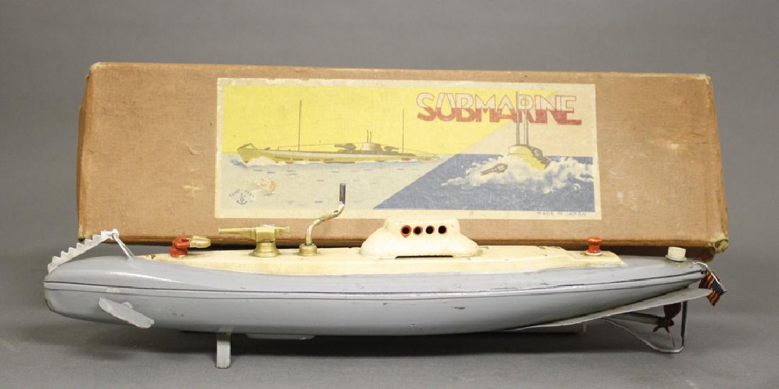 Submarine: Made by CK. Japan circa 1935. Made of Tin. 12.5" Long. The gyroscopic mechanism appears to need a minor adjustment to function. Very Fine Condition.