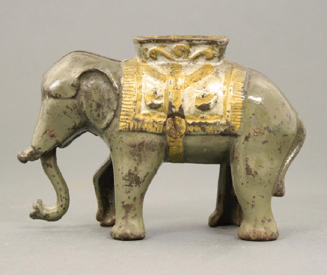 Small Elephant Swings Trunk: A. C. Williams circa 1900's. Made of Cast Iron. Fine Condition.