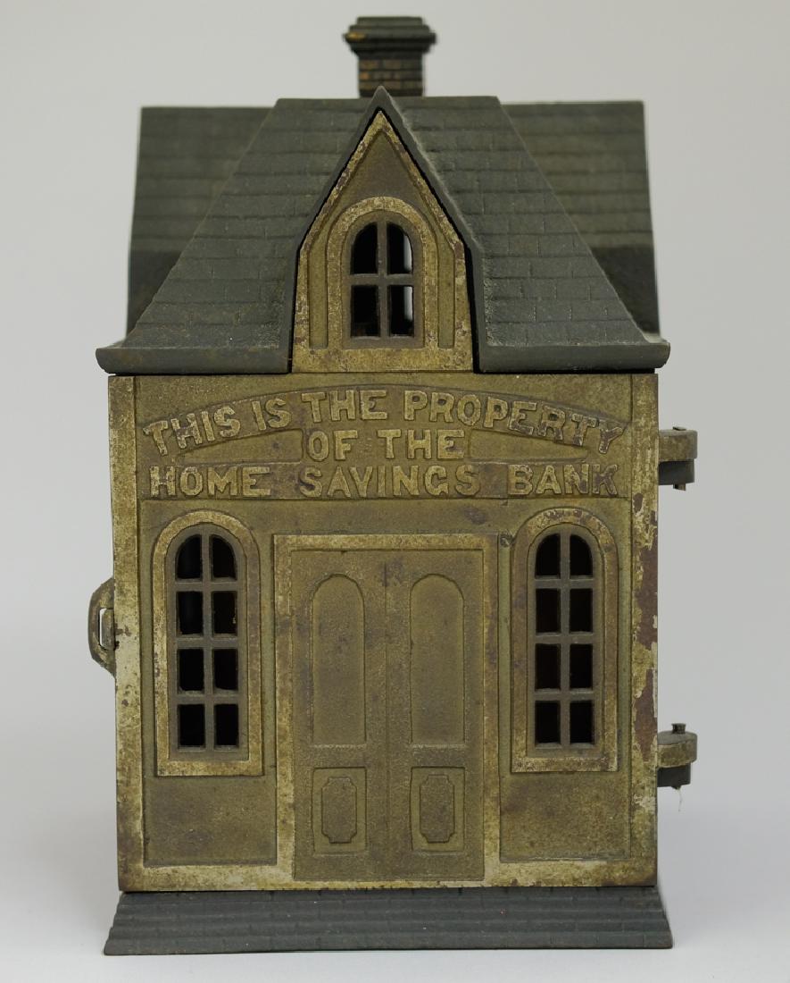 Home Savings Bank: Made in America. Made of Cast Iron. 10 1/2" Tall. Fine Condition (Retains Original Inserts).