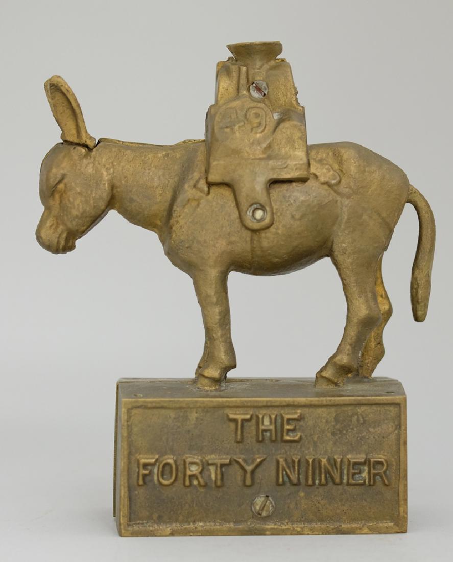 The Forty Niner: Made in America circa 1890's. Made of Cast Iron. This is a converted still bank. Excellent Condition.