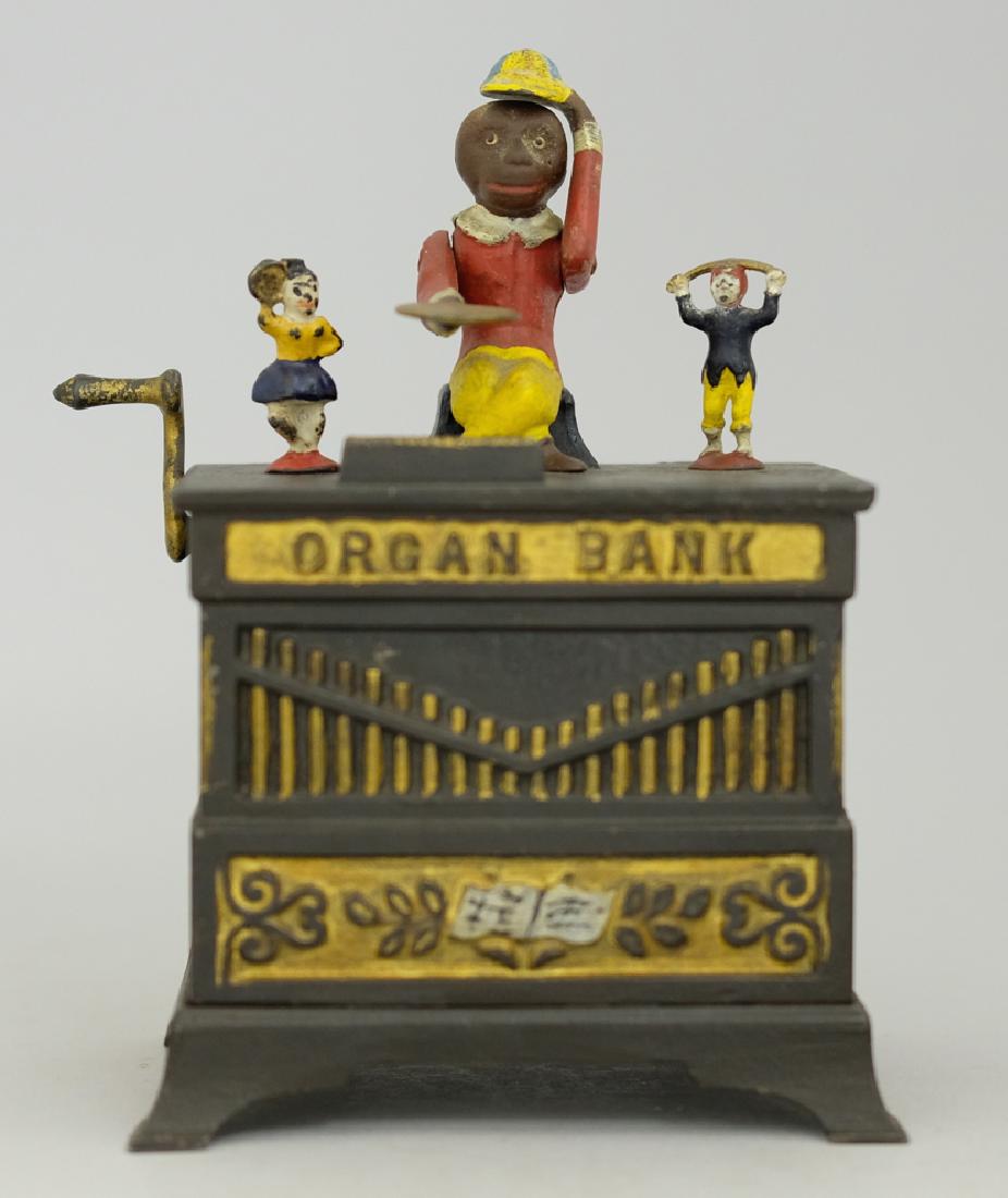 Organ with Boy and Girl Mechanical Bank: Made by Kyser & Rex circa 1880's. Made of Cast Iron. Repainted Condition.