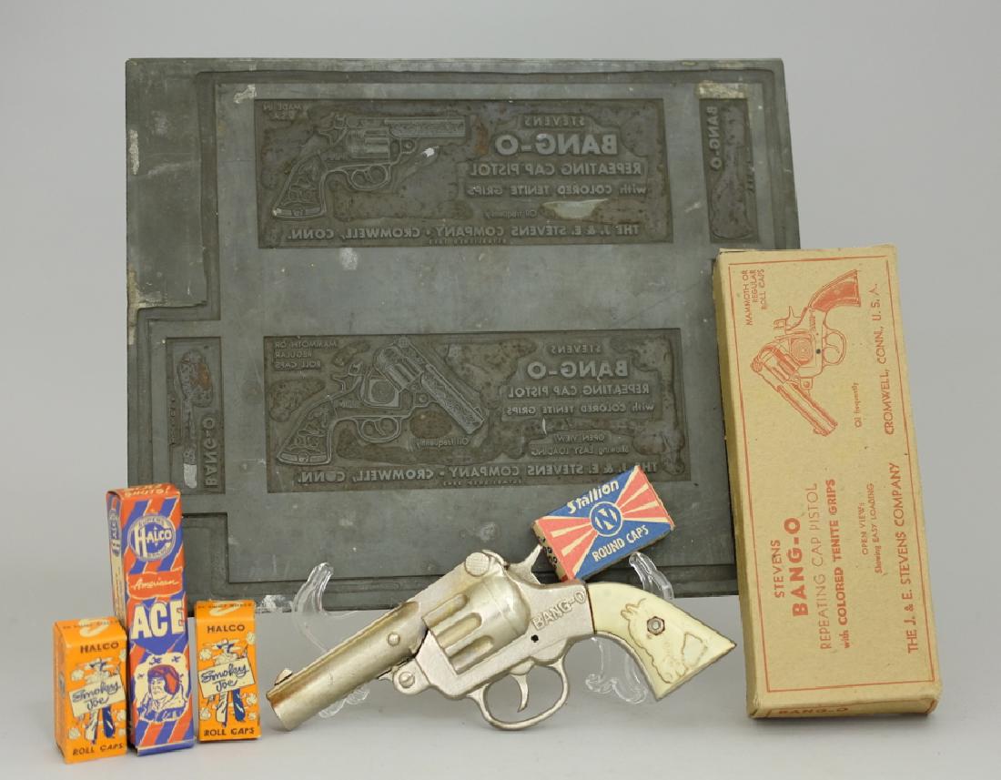 Bang-O Cap Gun / Misc. Cap Gun Accessories: Made by J. & E. Stevens. Made of Cast Iron. Also includes 4 boxes of caps and stamps for box labels. Pristine in Original Box.