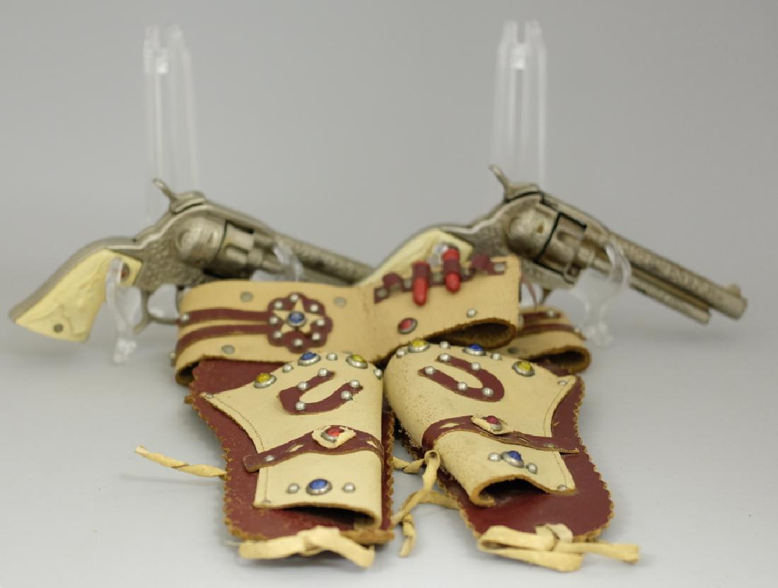 Cap Guns with Holster Belt: Made by Hubley. Made of Cast Iron and Leather. Very Fine Condition.