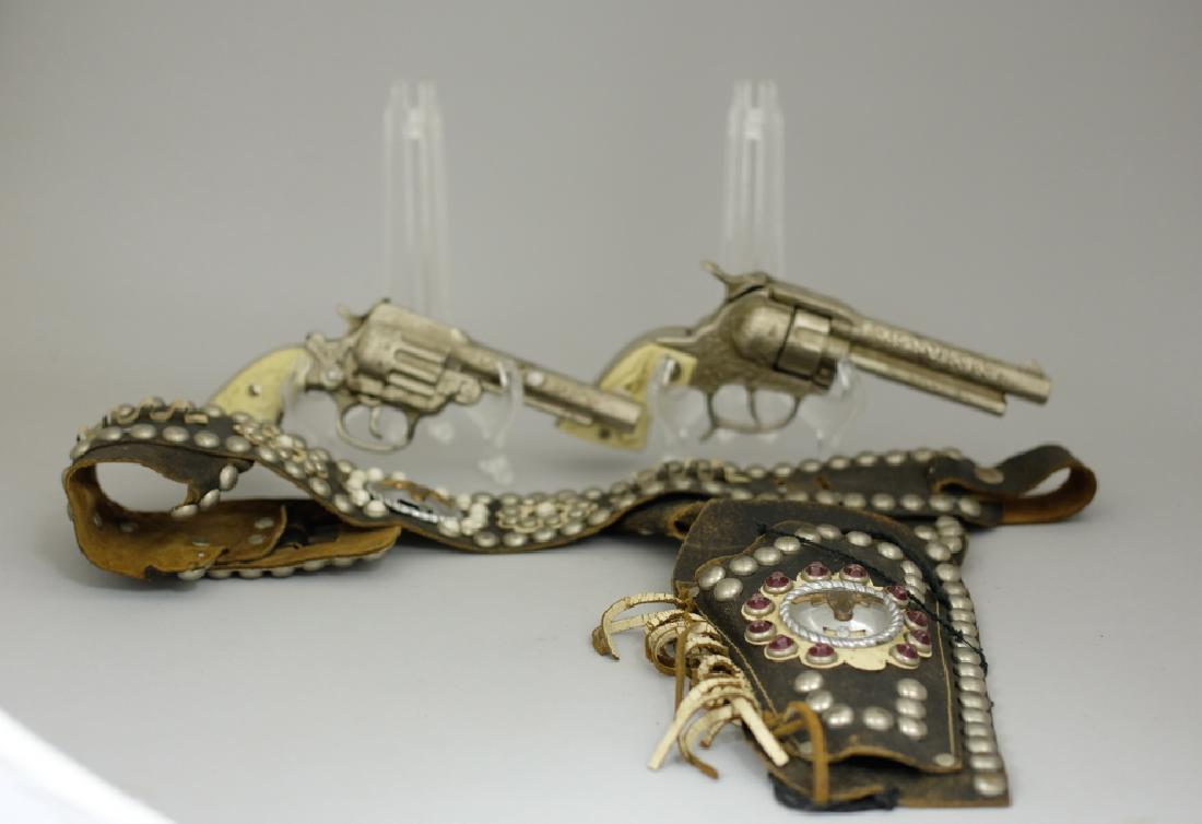 Cap Guns with Holster Belt: Made by Hubley. Made of Cast Iron and Leather. Very Fine Condition.