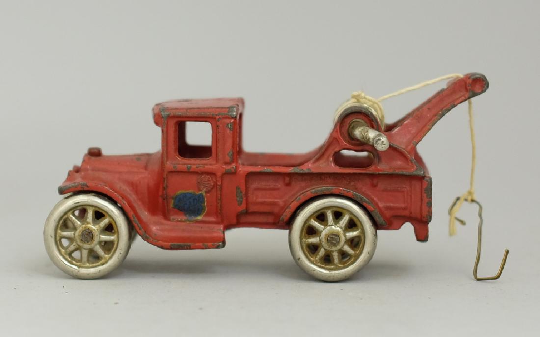 Tow Truck Cast Iron Toy: Made by Arcade circa 1920's. Made of Cast Iron. 5.5" Long. Very Fine Condition.