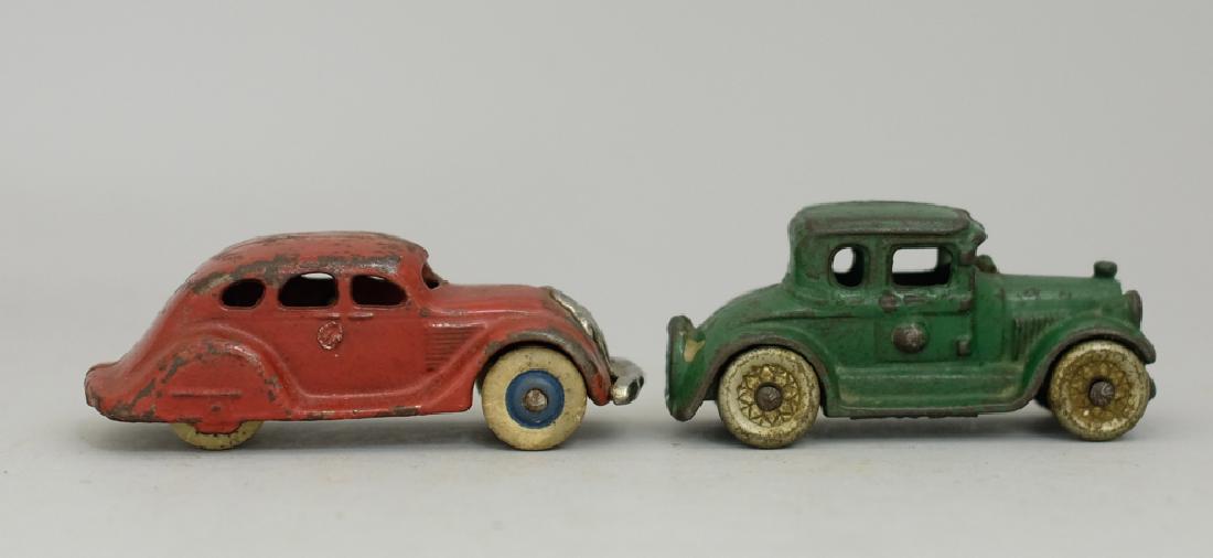 Two Cast Iron Car Toys: Made by A. C. Williams / Arcade circa 1920's/1930's. Made of Cast Iron (One with Rubber Tires). 3.5" - 3.75" Long. Good to Fine Condition.