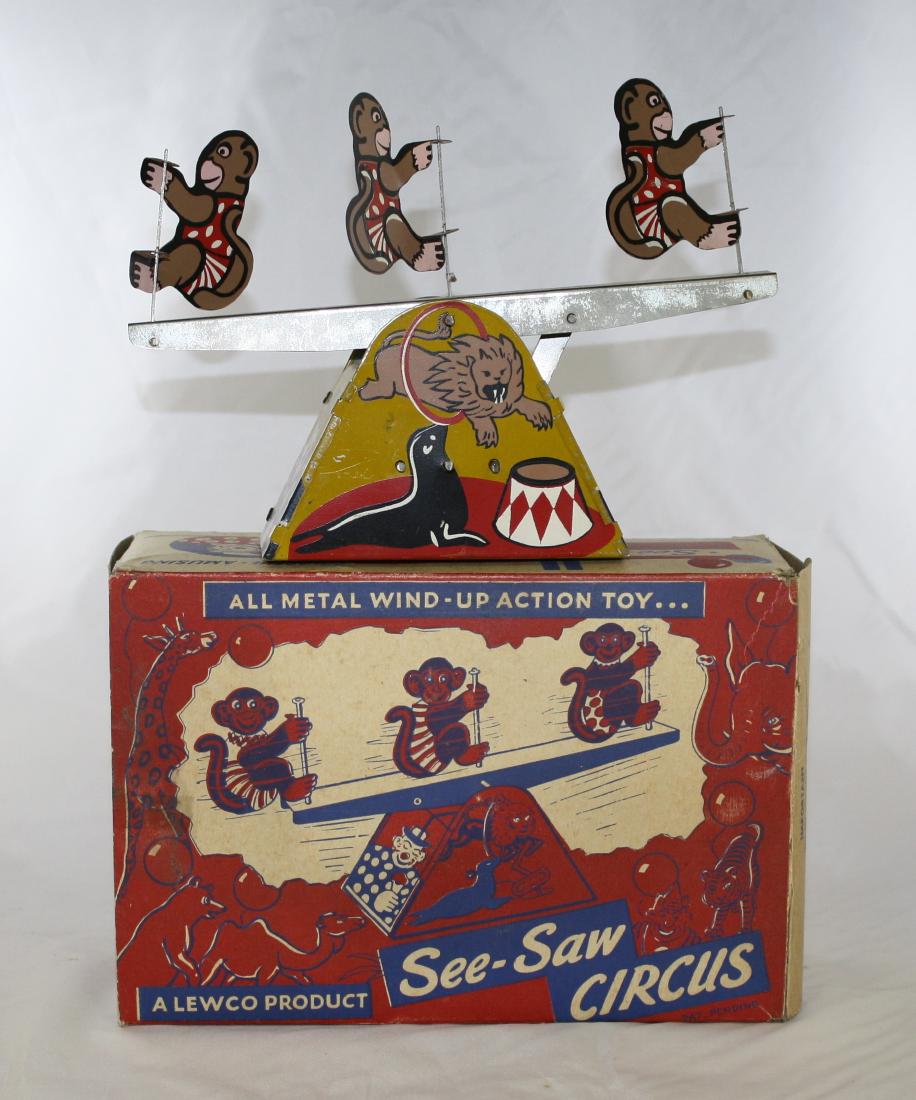 See-Saw Circus Toy: Made by Lewco Products. Made of Tin and Steel. 6 1/2" Tall x 9" Long. Works well. Excellent Condition with Original Box.