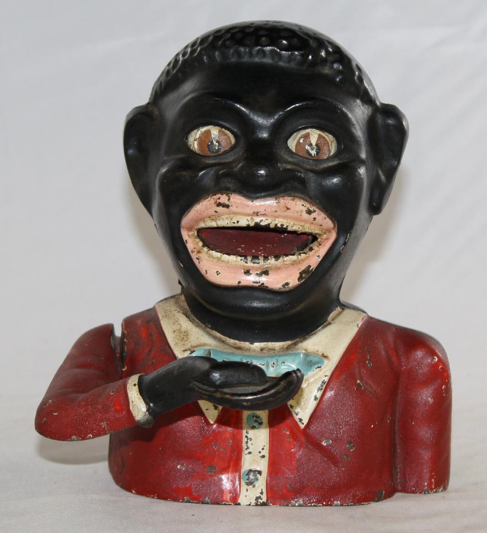 Jolly N. with Dagger Eyes Mechanical Bank: Made in England. Made of Cast Iron. Very Fine Condition.
